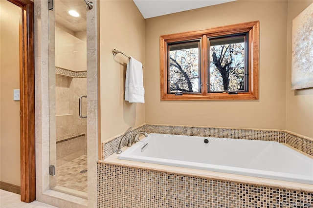 bathroom featuring separate shower and tub