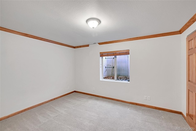 unfurnished room with crown molding, carpet flooring, and a textured ceiling