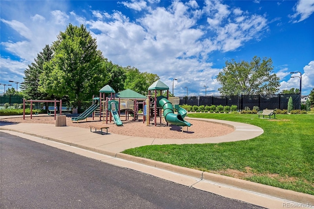 view of playground with a lawn