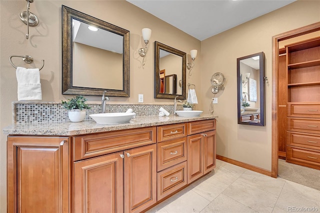 bathroom featuring tasteful backsplash, vanity, and tile patterned floors