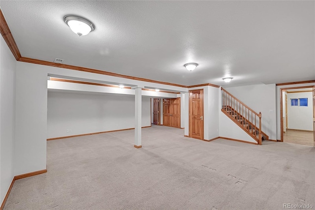 basement featuring crown molding, light carpet, and a textured ceiling