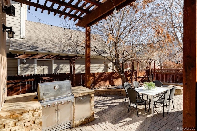 view of patio / terrace featuring a pergola, an outdoor kitchen, and grilling area