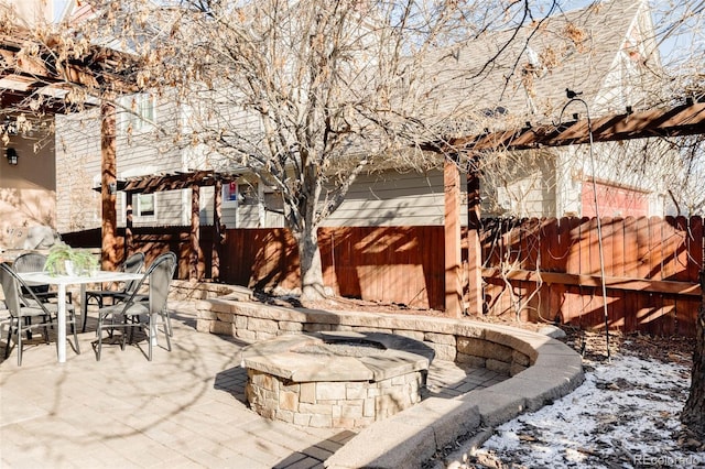 snow covered patio with a fire pit