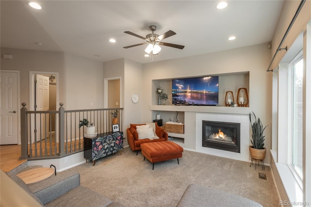 sitting room featuring ceiling fan, a tile fireplace, recessed lighting, carpet flooring, and baseboards