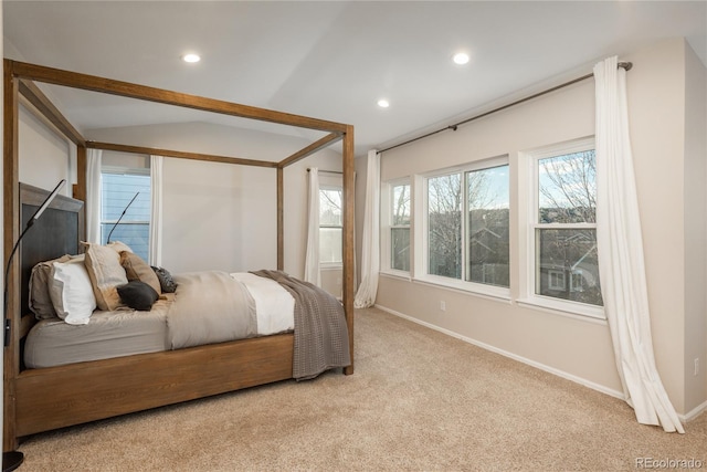 bedroom with lofted ceiling, light carpet, baseboards, and recessed lighting