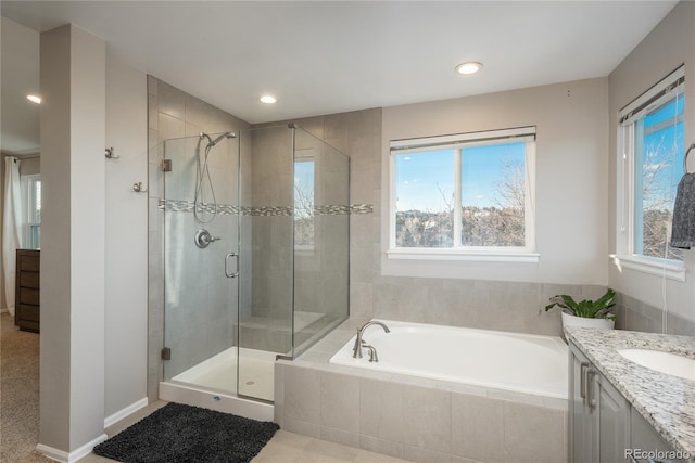 full bath with a stall shower, vanity, a bath, and recessed lighting