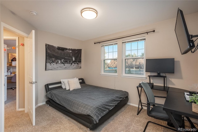 bedroom featuring baseboards and light colored carpet