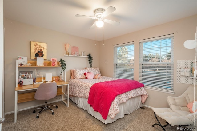 carpeted bedroom with baseboards and a ceiling fan