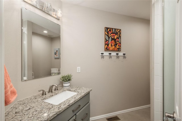 bathroom featuring visible vents, vanity, and baseboards