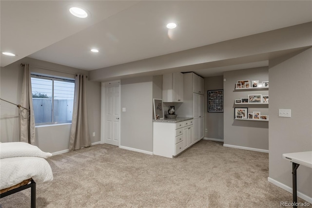 kitchen with light carpet, light countertops, and baseboards