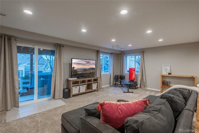 carpeted living area featuring recessed lighting and baseboards