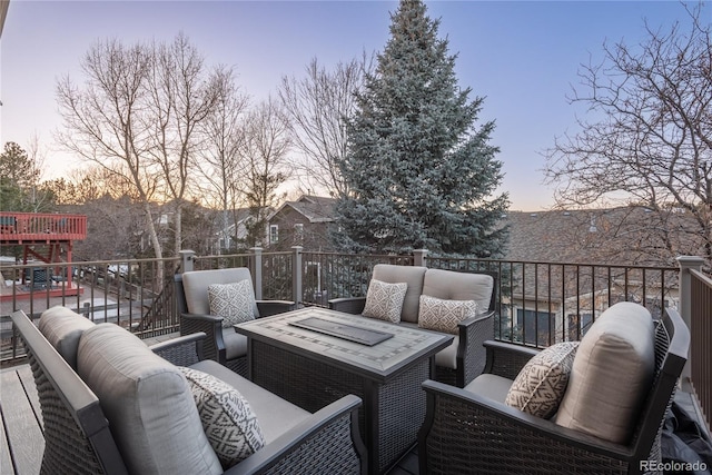 deck at dusk with an outdoor hangout area