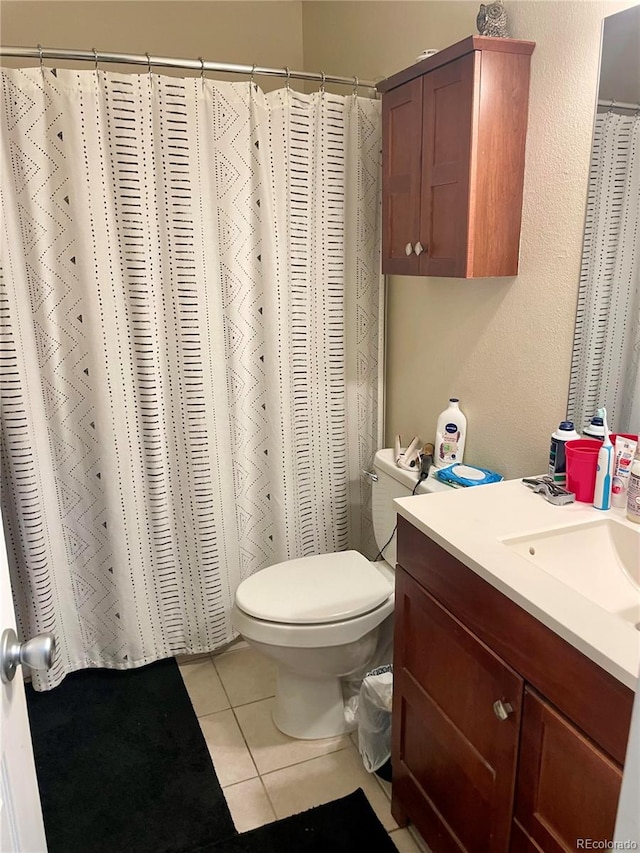 bathroom with vanity, toilet, and tile patterned floors