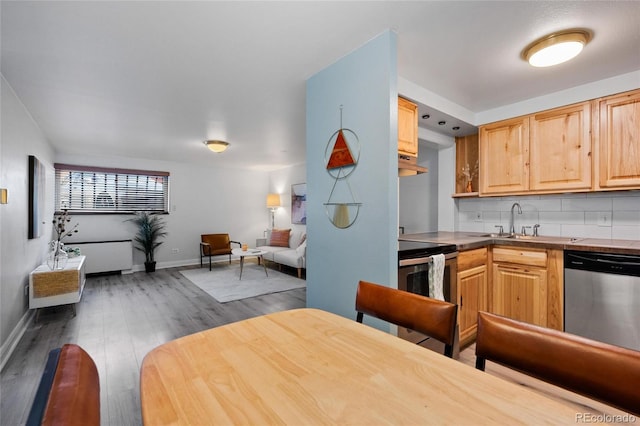 kitchen featuring light brown cabinets, stainless steel appliances, sink, dark hardwood / wood-style flooring, and tasteful backsplash