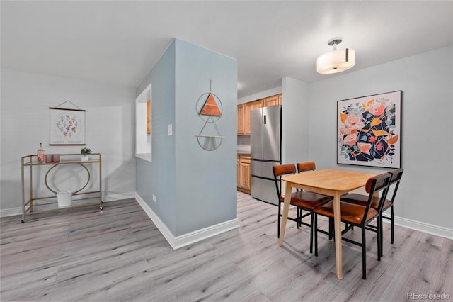 dining space featuring light wood-type flooring