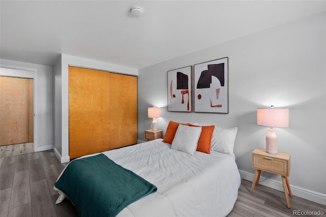 bedroom with hardwood / wood-style flooring and a closet