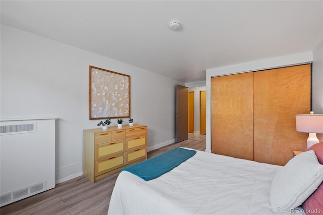 bedroom featuring a closet and light wood-type flooring