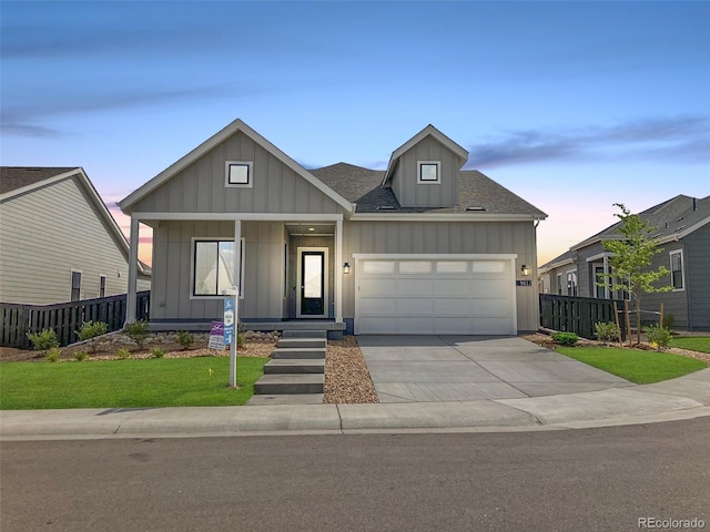 view of front of property with a lawn and a garage