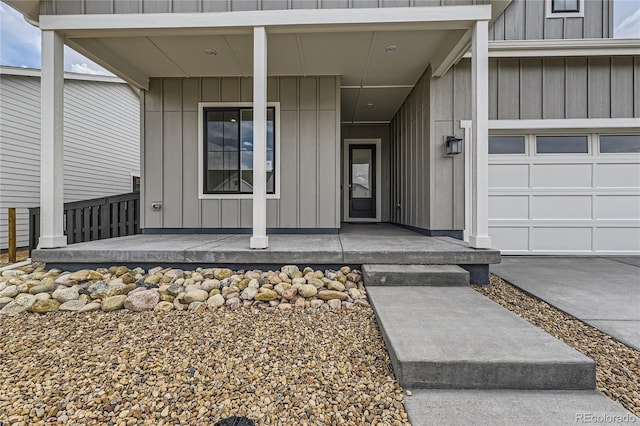 property entrance with a garage and covered porch