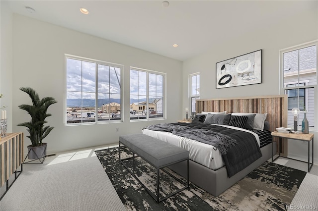 carpeted bedroom featuring multiple windows