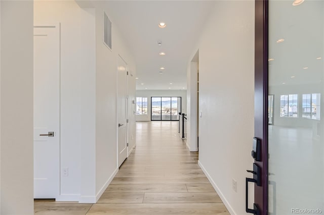 hallway with light hardwood / wood-style floors