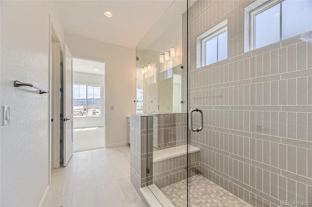 bathroom featuring tile patterned floors, a shower with door, and vanity