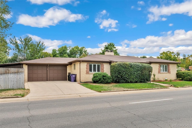 ranch-style home with a garage and a front yard