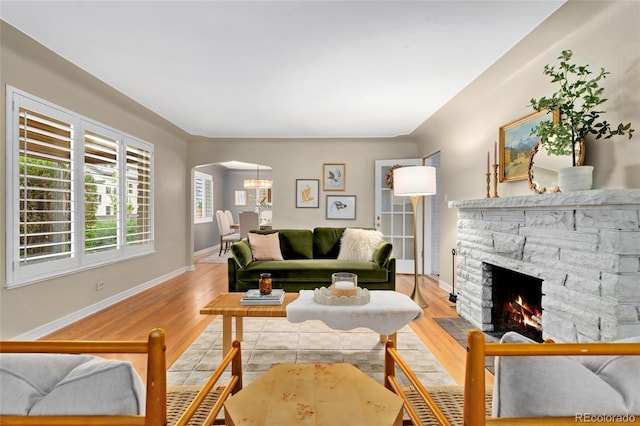 living room featuring a fireplace and light wood-type flooring