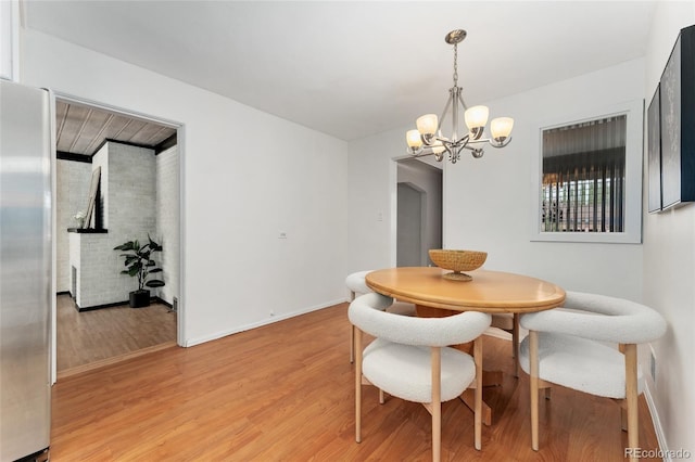 dining room with a chandelier and light hardwood / wood-style floors