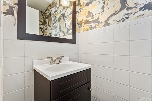 bathroom featuring vanity and tile walls