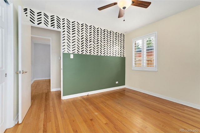 empty room with light hardwood / wood-style floors and ceiling fan