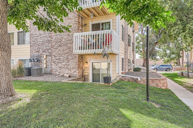 exterior space with a yard and a balcony