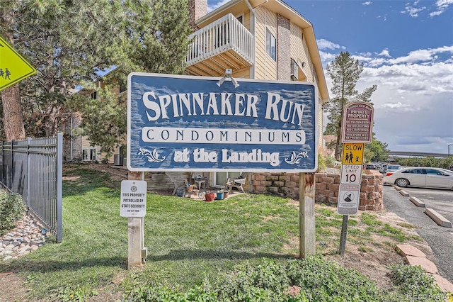 community sign featuring a lawn