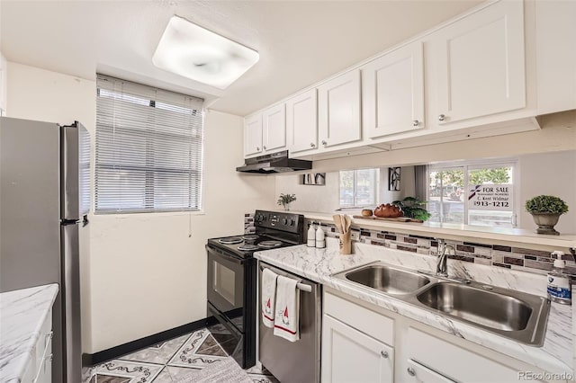 kitchen with sink, decorative backsplash, light stone countertops, white cabinets, and appliances with stainless steel finishes