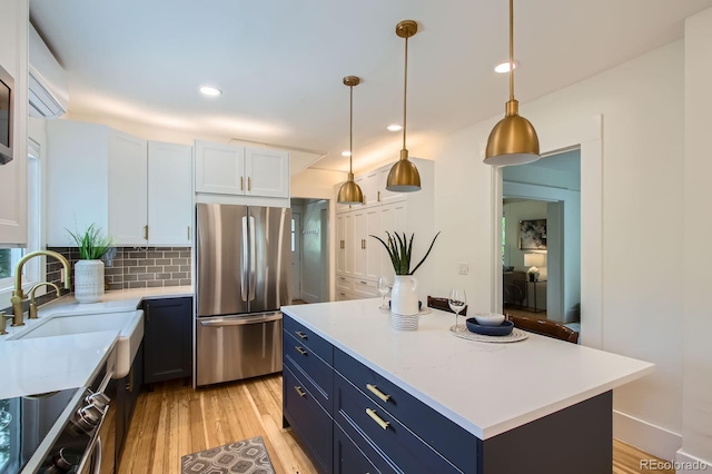 1519 16th St, Boulder, CO 80302 - kitchen featuring freestanding refrigerator, blue cabinetry, light wood-style floors, and recessed lighting