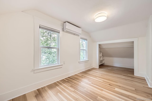 1519 16th St, Boulder, CO 80302 - additional living space with a wall mounted AC, lofted ceiling, light wood-style flooring, and baseboards