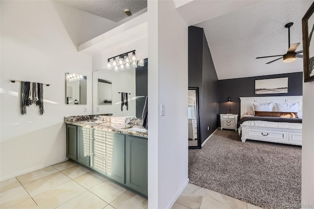 bathroom with vanity, a textured ceiling, ceiling fan, high vaulted ceiling, and tile patterned flooring