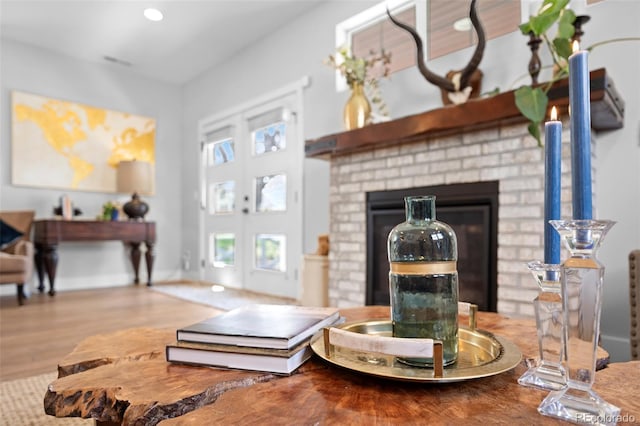 living area with wood finished floors and a fireplace