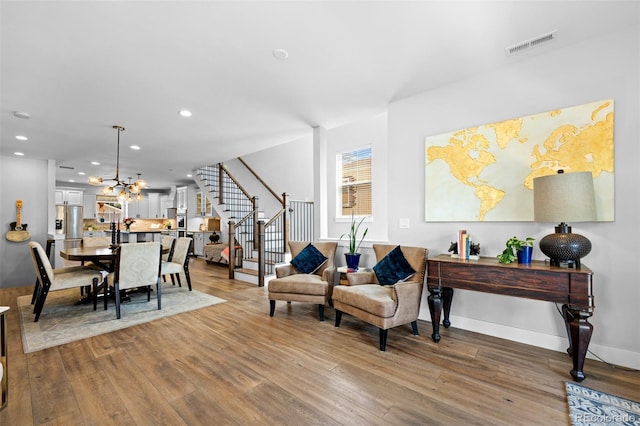 interior space with recessed lighting, stairs, wood finished floors, and visible vents
