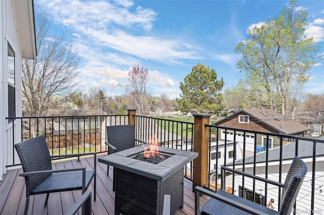 wooden deck featuring a fire pit