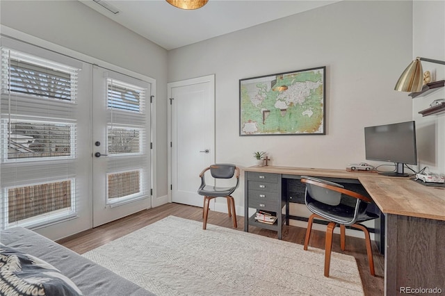 office area featuring baseboards, french doors, and wood finished floors