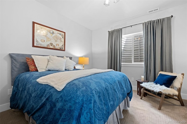 carpeted bedroom with baseboards, vaulted ceiling, and visible vents