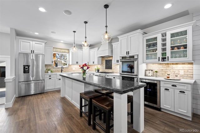 2948 S Clarkson St, Englewood, CO 80113 - kitchen featuring stainless steel appliances, wine cooler, a kitchen bar, backsplash, and recessed lighting