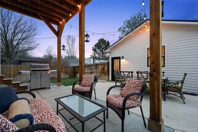2948 S Clarkson St, Englewood, CO 80113 - patio terrace at dusk with a fenced backyard, outdoor dining space, and grilling area