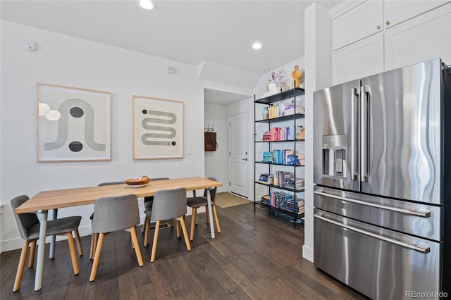 dining space with dark hardwood / wood-style flooring