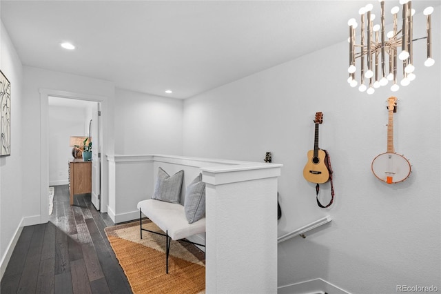 sitting room featuring dark hardwood / wood-style floors and an inviting chandelier