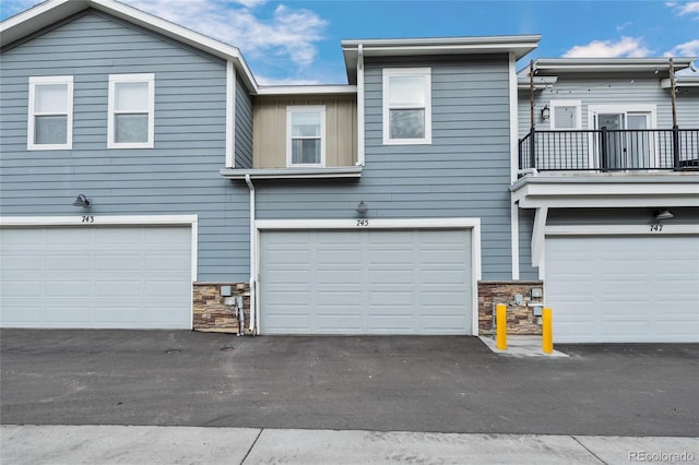 multi unit property featuring a balcony and a garage