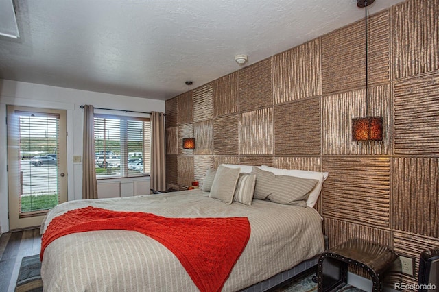 bedroom with hardwood / wood-style flooring and a textured ceiling