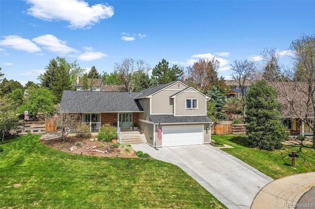 10743 W Turtle Mtn, Littleton, CO 80127 - split level home with concrete driveway, a garage, a front lawn, covered porch, and stucco siding