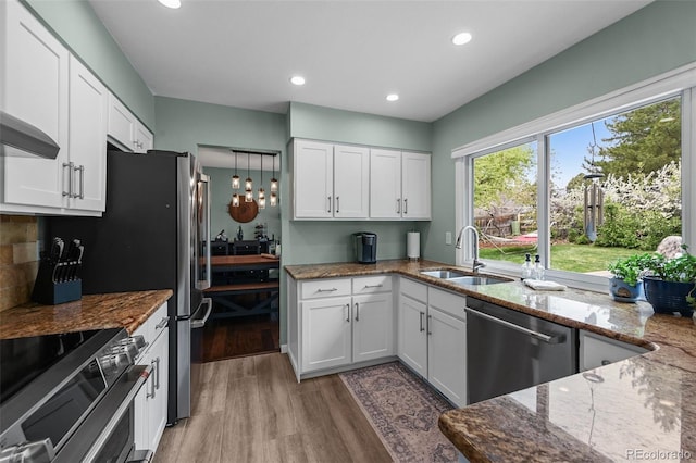 10743 W Turtle Mtn, Littleton, CO 80127 - kitchen with a sink, appliances with stainless steel finishes, light wood finished floors, dark stone countertops, and recessed lighting